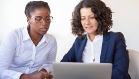 Multiethnic_employees_looking_at_laptop